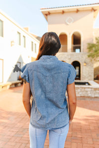 Denim top with pearl snap buttons