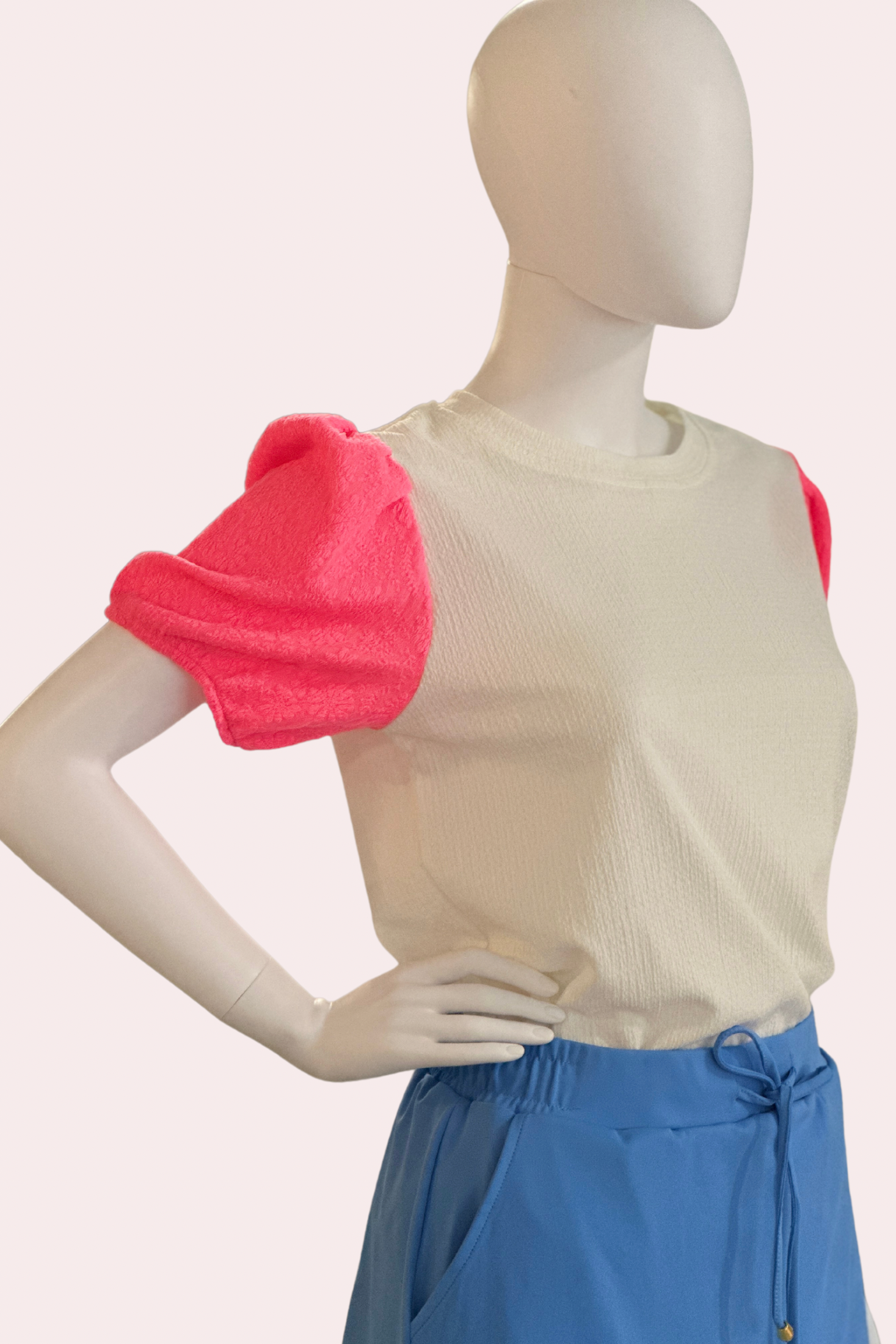 White textured top with neon pink puff sleeves