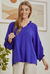 Royal blue top with ruffle neck detail