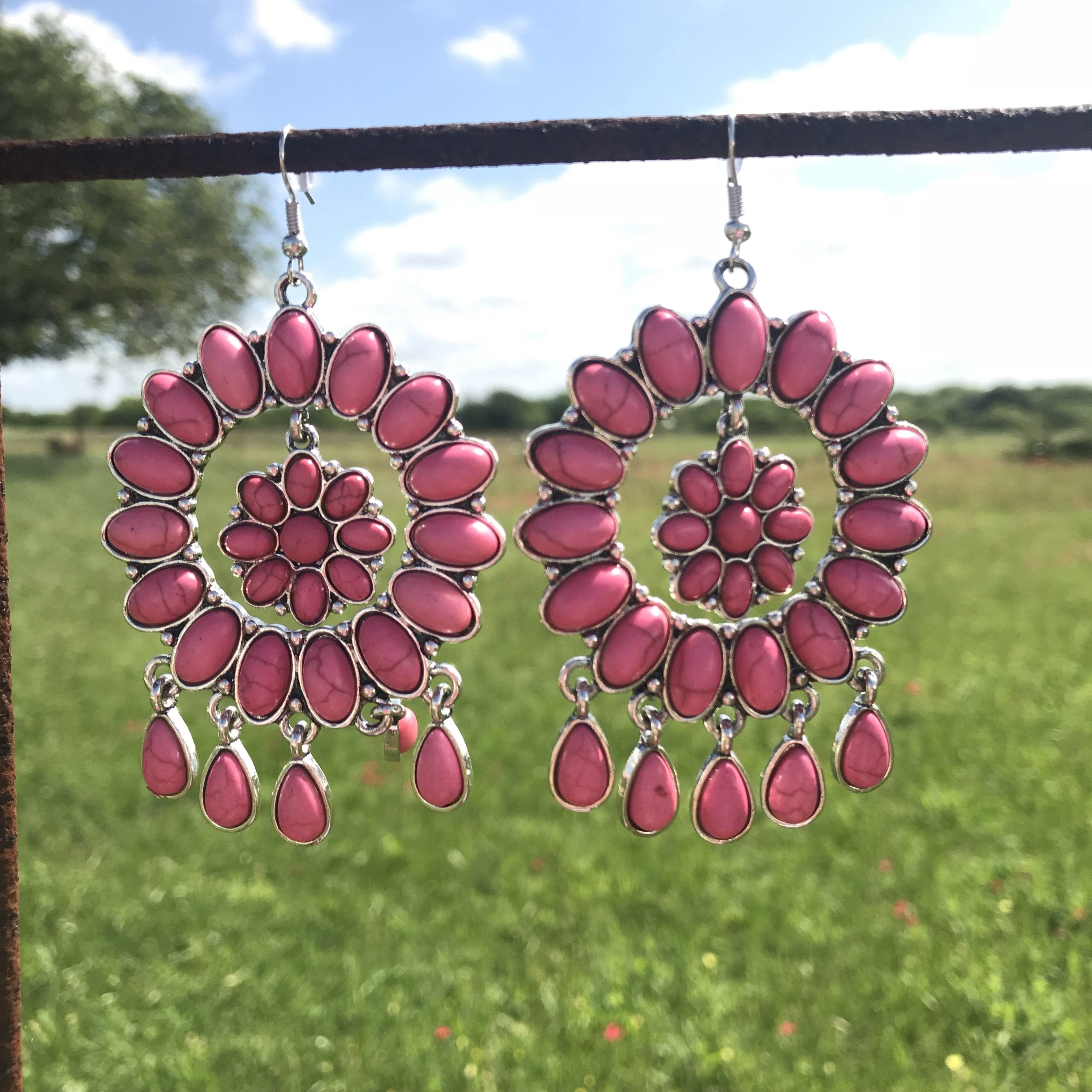 Pink dangle earrings with flower concho